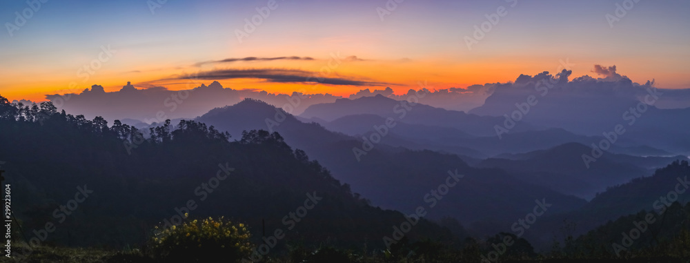 Obraz premium Sunset or sunrise mountain peaks colorful sky panorama.