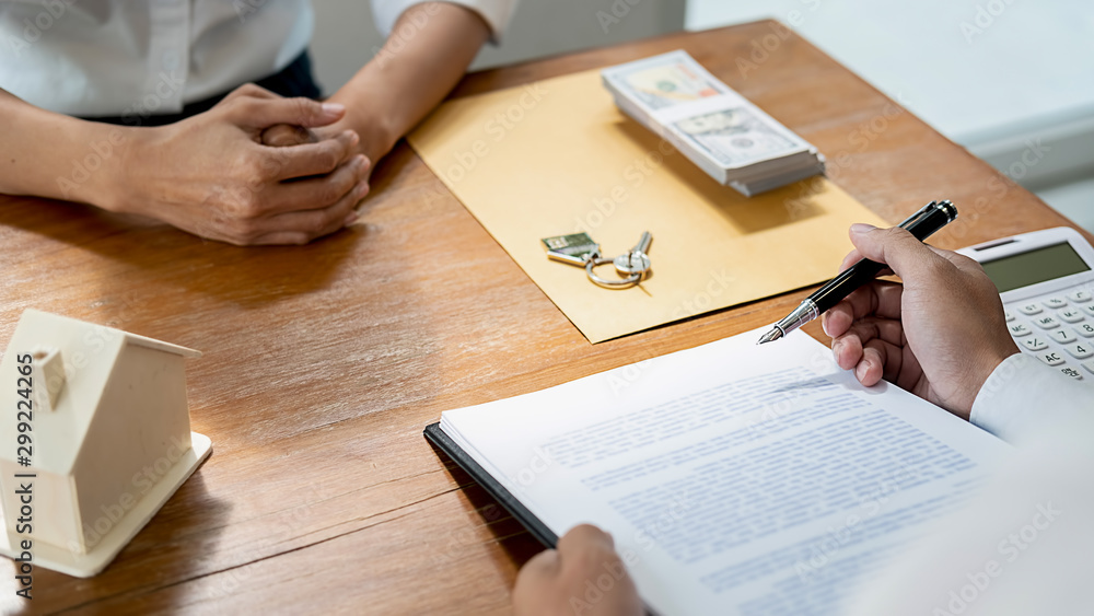 Real estate agent and customer signing contract to buy house, insurance or loan real estate. Real estate agent and customer signing contract to buy house, insurance or loan real estate.
