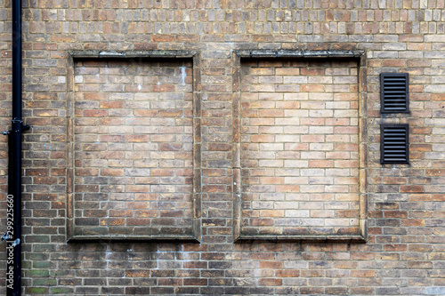 Abstract weathered stained background of brick wall texture, grungy rusty architecture wallpaper with text space © AnnaMoskvina