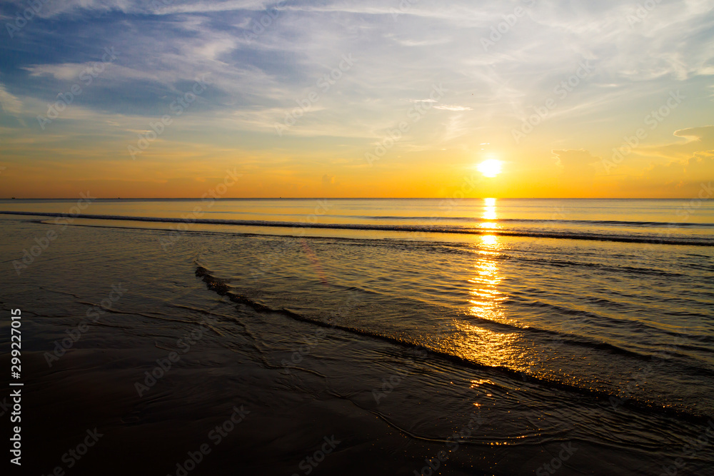 Sunrise with shining beautiful on wave at beach