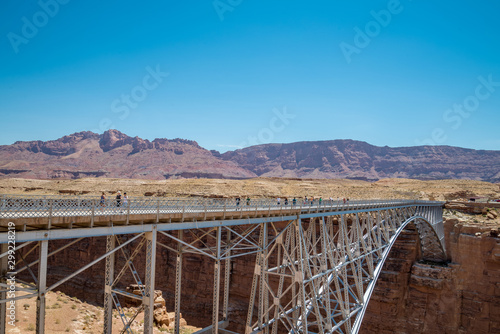 Historic Navajo steel bridges over Colorado River spans marble Grand Canyon and red rocky mountain landscape in northern Arizona with clear blue sky