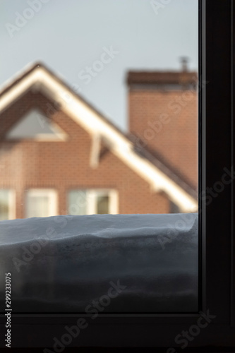 A thick layer of snow lies outside the window.