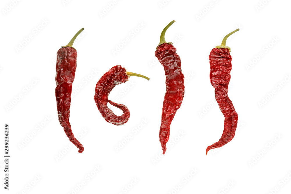 Red dried chilli peppers on a white isolated background. Red dried chilli peppers on a white isolated background.