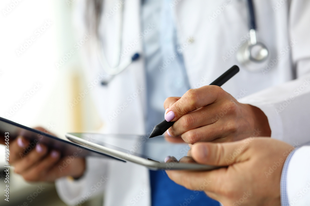 Female GP making electronic notes in tablet pc Female GP making electronic notes in tablet pc