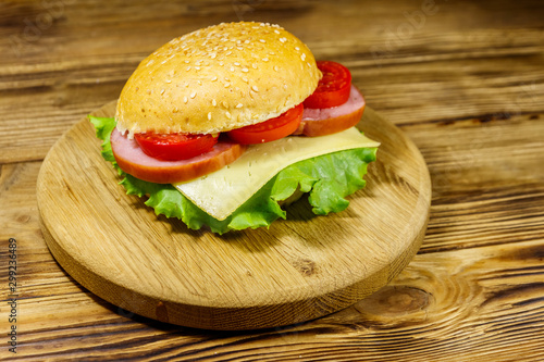Fresh delicious homemade cheeseburger on wooden table