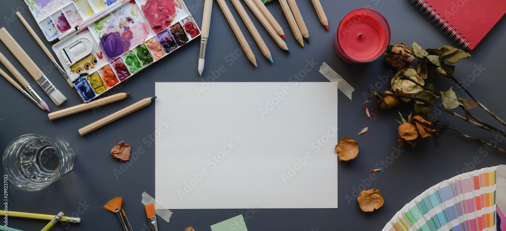 Top view of artist studio with sketch paper, painting tools, water colours  and office supplies Stock Photo | Adobe Stock