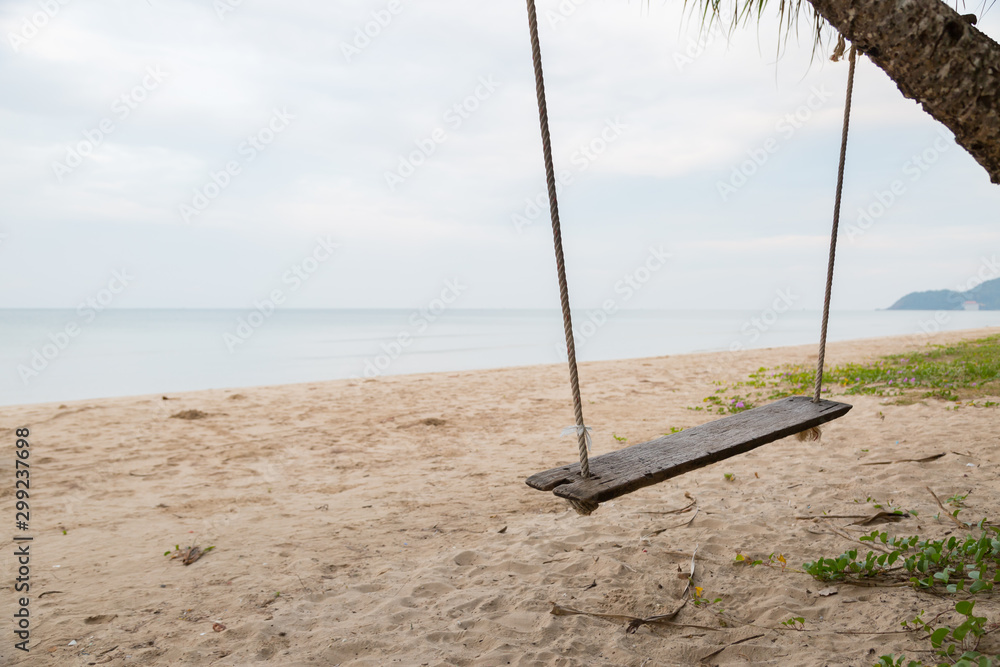 Fototapeta premium Wood swing at the beach and sand