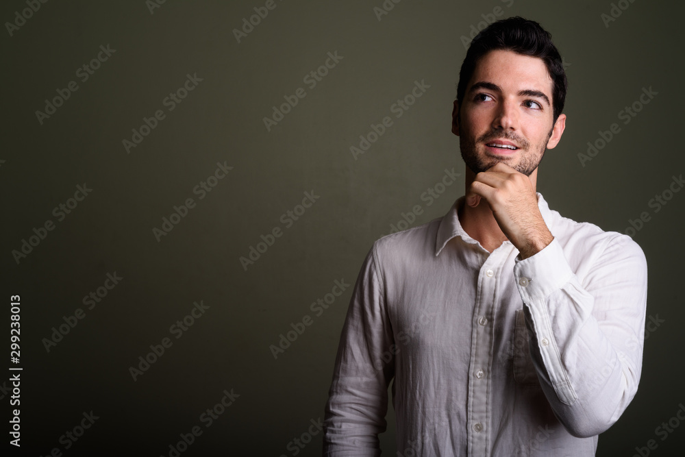 Portrait of young handsome businessman with stubble beard