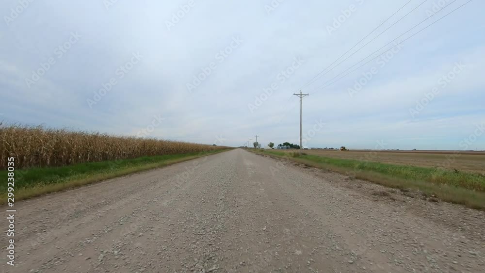 POV through driver's window while driving through rural Iowa; viewing farmstead, trees, ditches and fields POV through driver's window while driving through rural Iowa; viewing farmstead, trees, ditches and fields