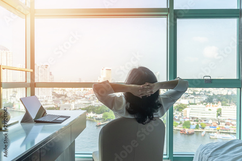 Work-life balance relaxation with Asian working business woman healthy lifestyle take it easy resting in comfort city hotel or home living room having good time with peace of mind, self-satisfaction #299241047