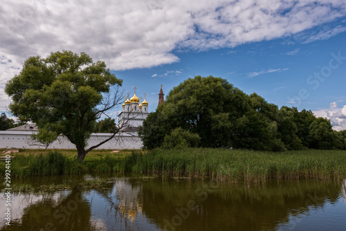 View of the central Cathedral from the side of the lake between the trees. Russian shrines. Joseph-Volotsky Monastery in Teryaev. Moscow region, Teryaevo.