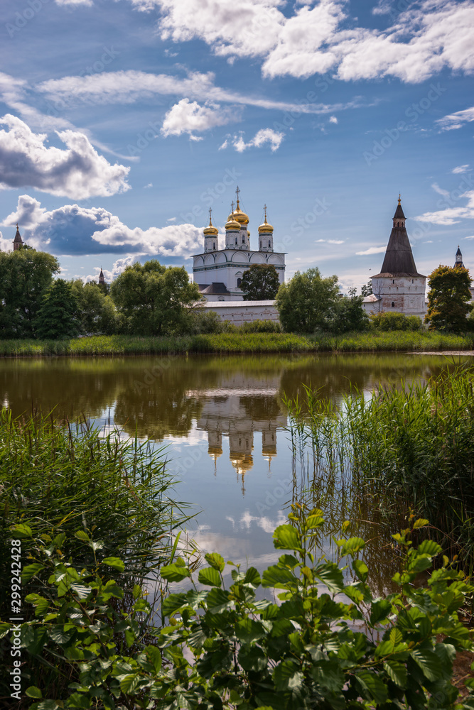 The Central Temple of the monastery is reflected in the water surface of the lake. Russian shrines. Joseph-Volotsky Monastery in Teryaev. Moscow region, Teryaevo.