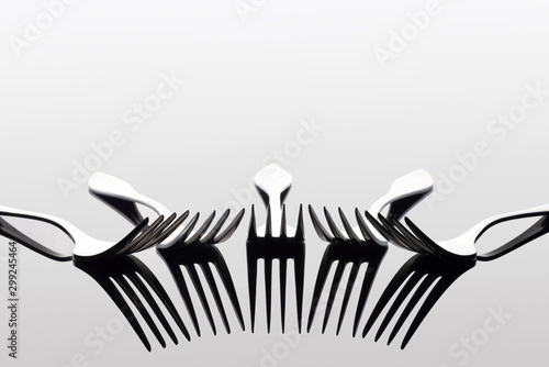 light and shadow of forks on white background