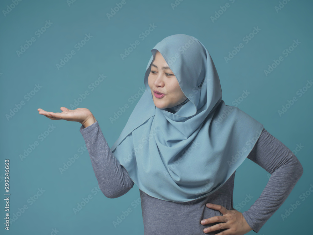 Muslim Lady Presenting Something on Her Side with Copy Space Muslim Lady Presenting Something on Her Side with Copy Space