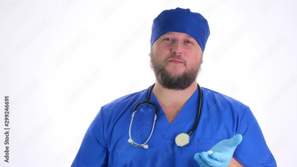 Nice chubby doctor with a beard in a blue coat and blue hat Nice chubby doctor with a beard in a blue coat and blue hat