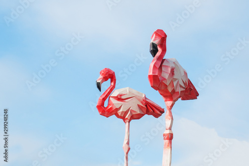 Cardboard Flamingo decoration against the blue sky.