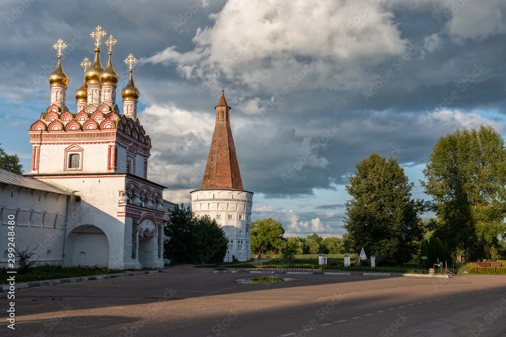Main entrance, watchtower and dramatic clouds. Russian shrines. Joseph-Volotsky Monastery in Teryaev. Moscow region, Teryaevo.