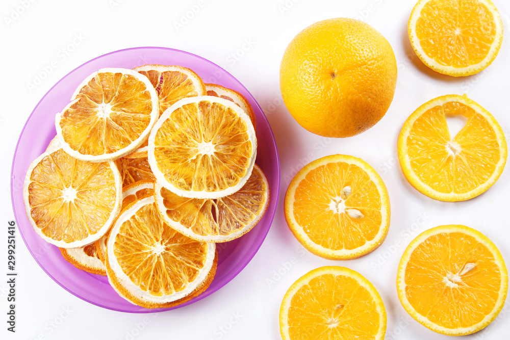 Ingredients for healthy fruit chips made of orange on white background. Vegetarian dietary food Ingredients for healthy fruit chips made of orange on white background. Vegetarian dietary food