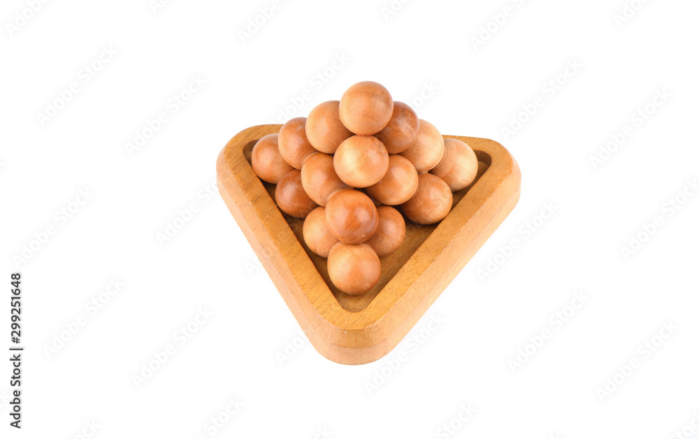 Three-dimensional wooden puzzle pyramid of balls isolated on a white background. Three-dimensional wooden puzzle pyramid of balls isolated on a white background.