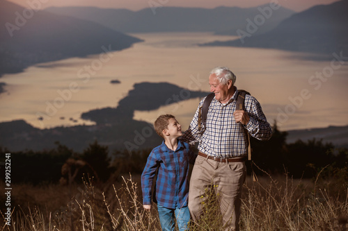 Grandfather and grandson hiking together.