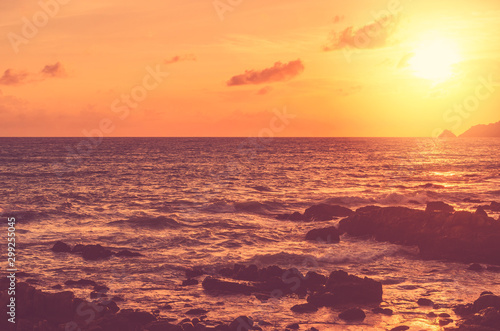 Wave splash on rock in sunset beach background. Copy space of outdoor summer vacation and business travel adventure concept.