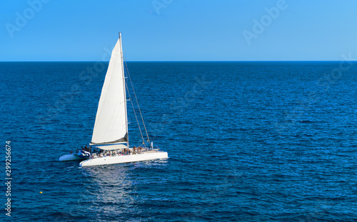 Sailboat in the sea with ongoing party aboard. Spain, Europe © Filk