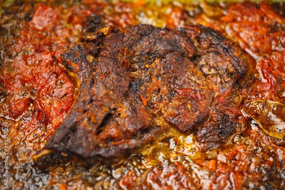 meat with tomato baked in the oven, close-up view meat with tomato baked in the oven, close-up view