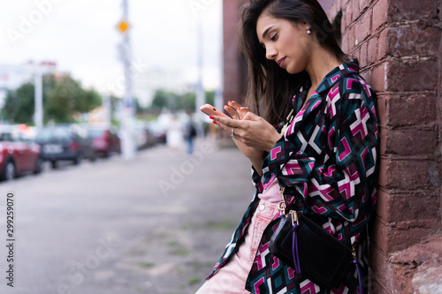 Natural young woman reading an sms or text message on a mobile phone