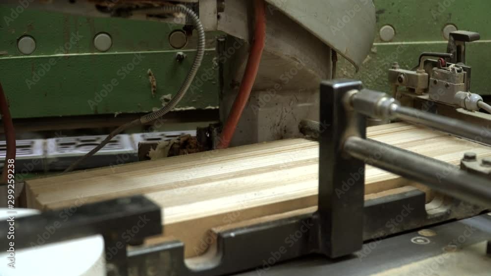 Gluing particleboard elements to furniture components. Chipboard edge is glued into wooden parts on edge processing machine. Close up shot of production line. Gluing particleboard elements to furniture components. Chipboard edge is glued into wooden parts on edge processing machine. Close up shot of production line.