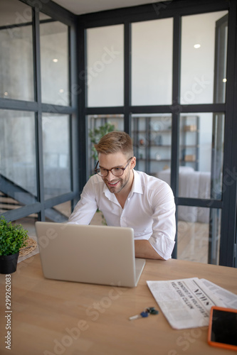 Businessman sitting in his living room and working on laptop