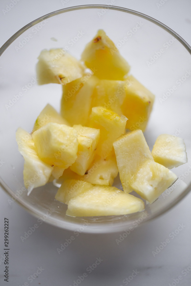 Pineapple in the bowl on marble background Pineapple in the bowl on marble background