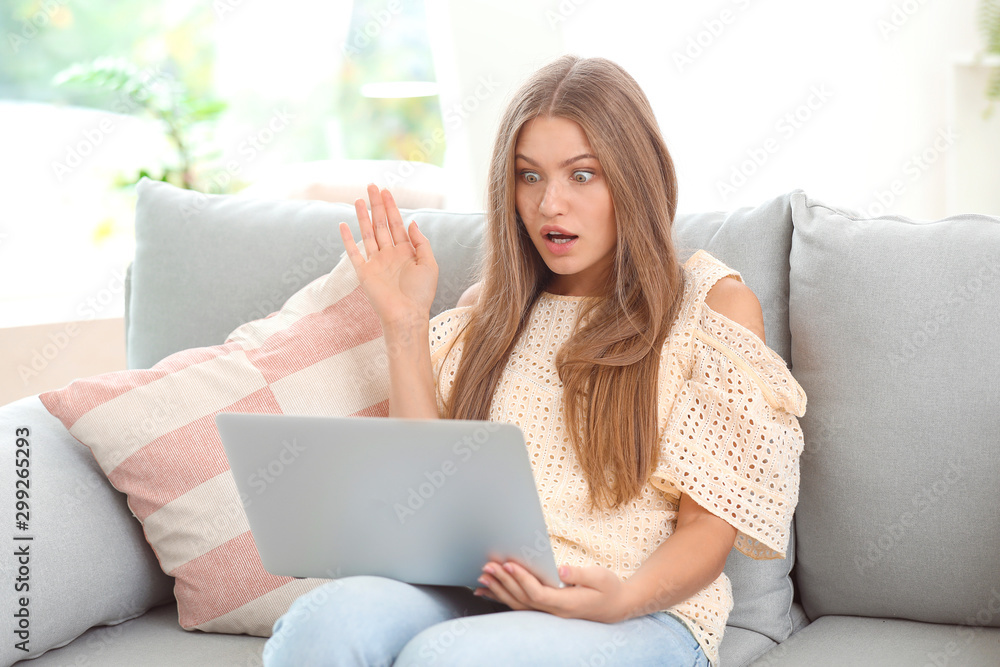 Surprised young woman with laptop at home Surprised young woman with laptop at home