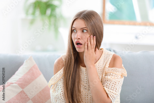 Surprised young woman at home