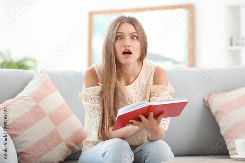 Surprised young woman readi...