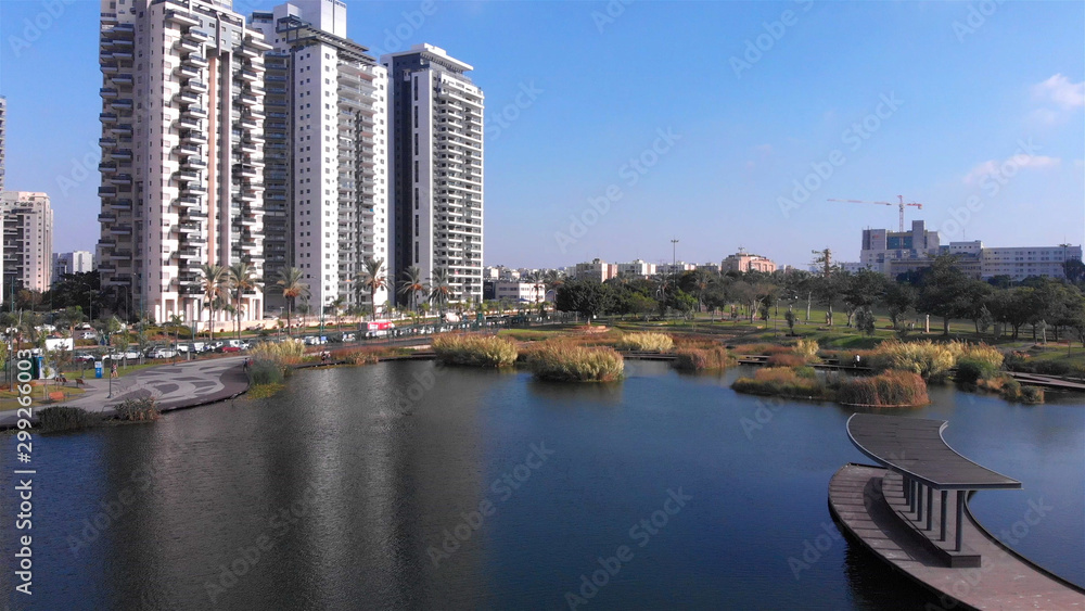 Drone Image over Lake Palm Trees And Modern Buildings aerial View, Israel