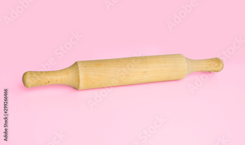 Kitchen utensils-rolling pin for rolling dough on pink background. Cooking tools.