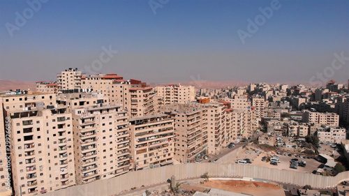 East Jerusalem Palestinian Refugge camp Surrounded By security Concerete Wall Drone Footage of Palestinian Refugge camp Shuafat With Security fence and Army Watch Tower photo