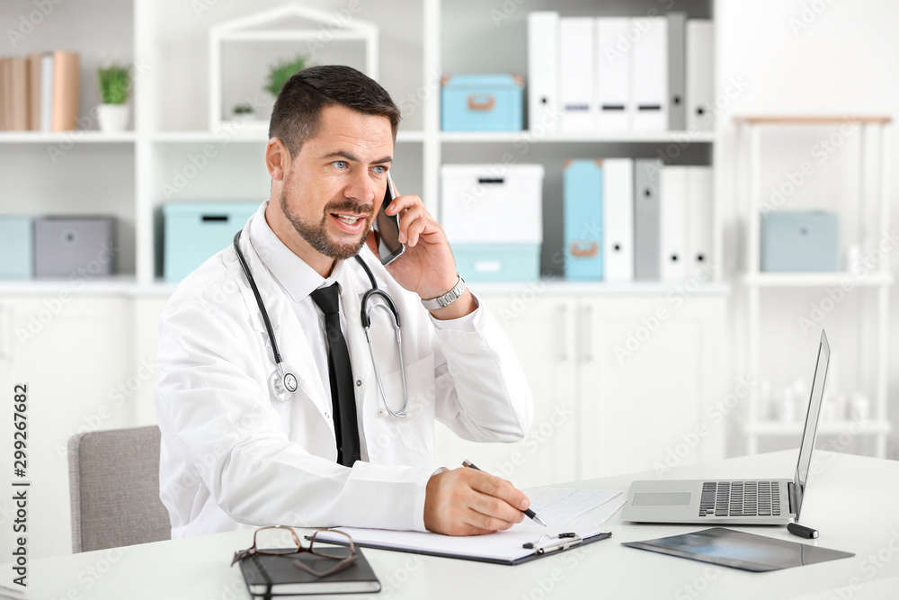 Fototapeta premium Male doctor working in clinic