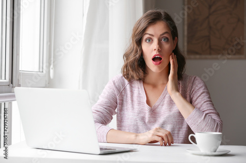 Surprised young woman with ...