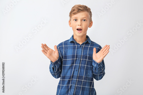Surprised little boy on whi...