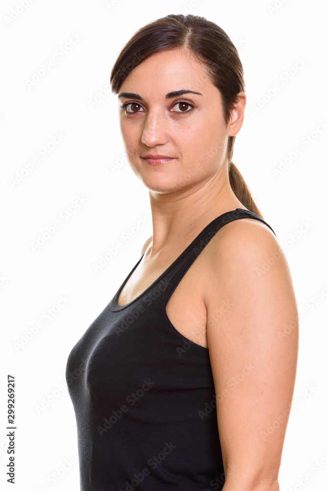 Closeup profile view of young beautiful woman looking at camera Closeup profile view of young beautiful woman looking at camera