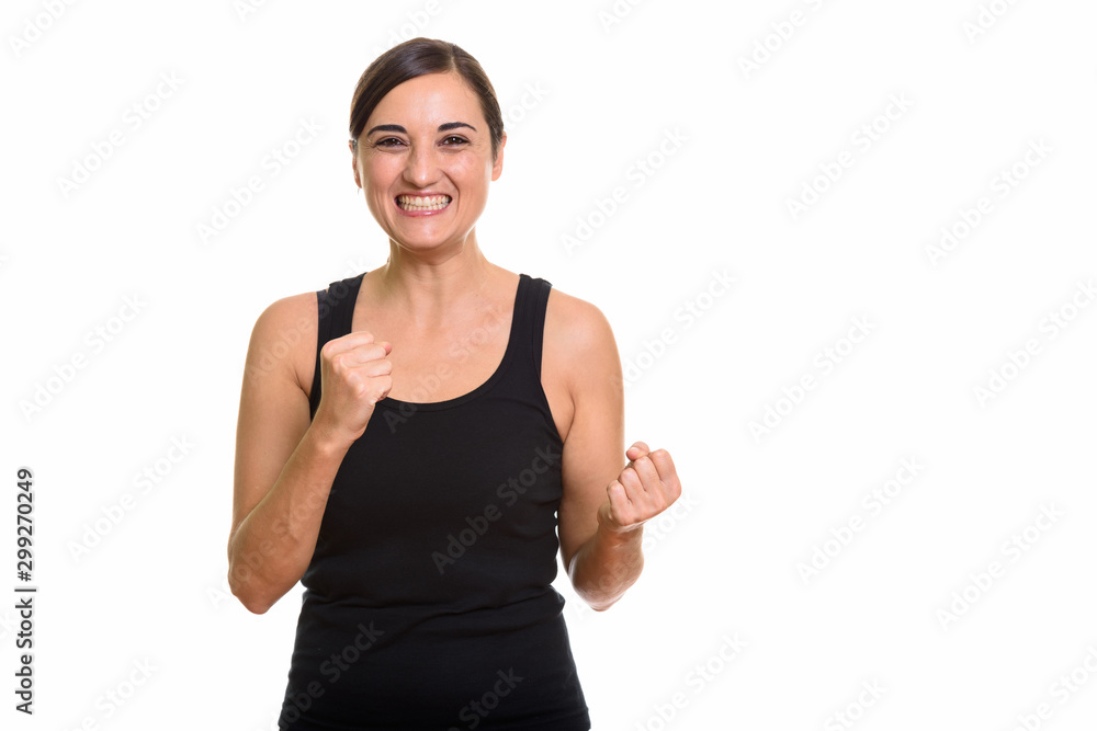 Studio shot of happy beautiful woman smiling and looking excited Studio shot of happy beautiful woman smiling and looking excited