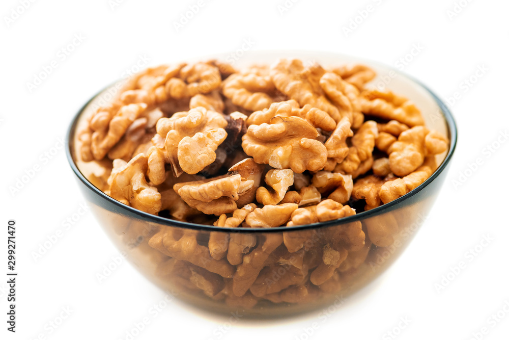 Studio photo of bowl with heap of peeled walnuts isolated on white Studio photo of bowl with heap of peeled walnuts isolated on white