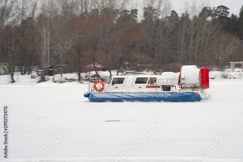 Rescue hovercraft gliding on frozen river, Russia