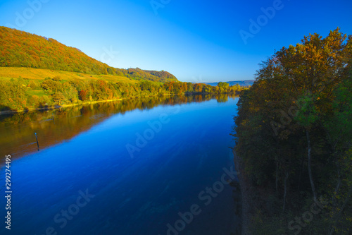 The river Rhine, only a few hundred meters young, after leaving Lake Constance. Autumn. Near the Swiss town Stein am Rhein. View from the car bridge to the west, the road leads to the Rhine Falls.