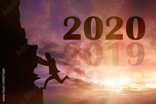 Silhouette of businessman climbing on go to 2020