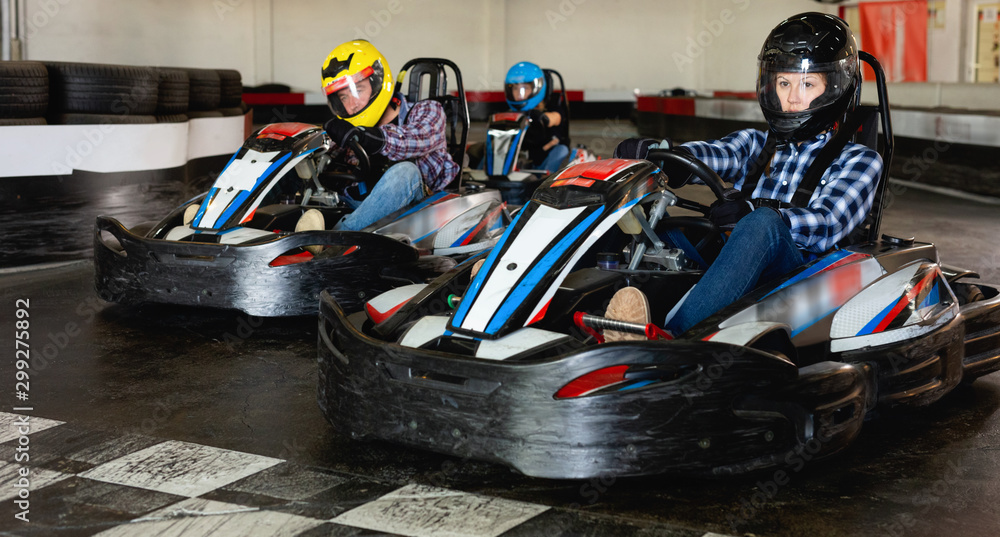 Group of people driving go-carts at racing track