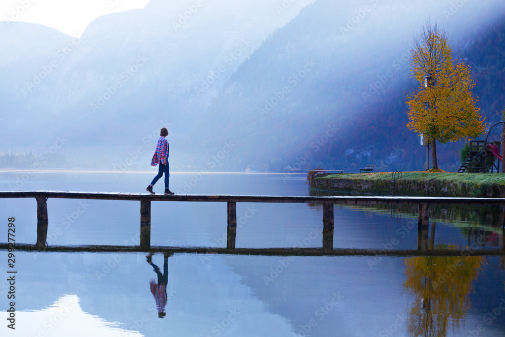 girl stands on a wooden bridge