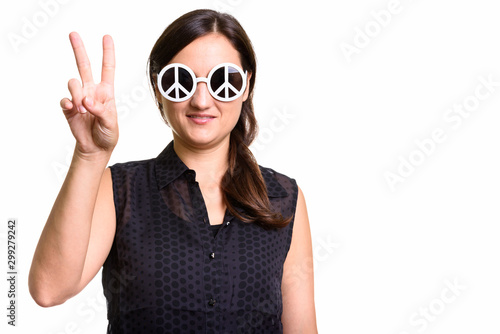 Portrait of beautiful woman wearing sunglasses with peace sign and posing