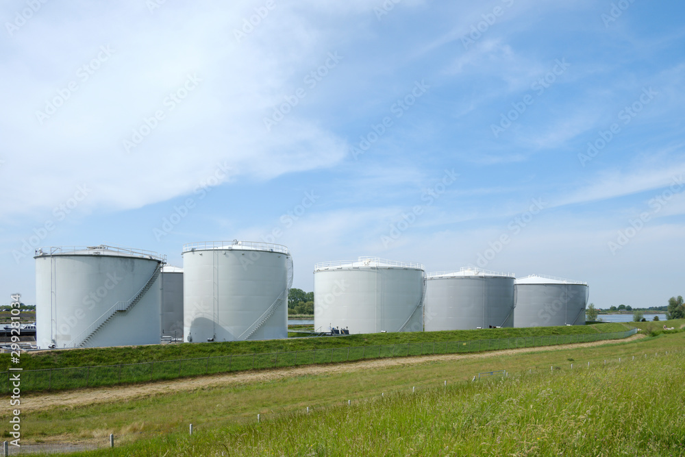 large storage tanks for fossil fuels on a river for further distribution to customers and gas stations large storage tanks for fossil fuels on a river for further distribution to customers and gas stations